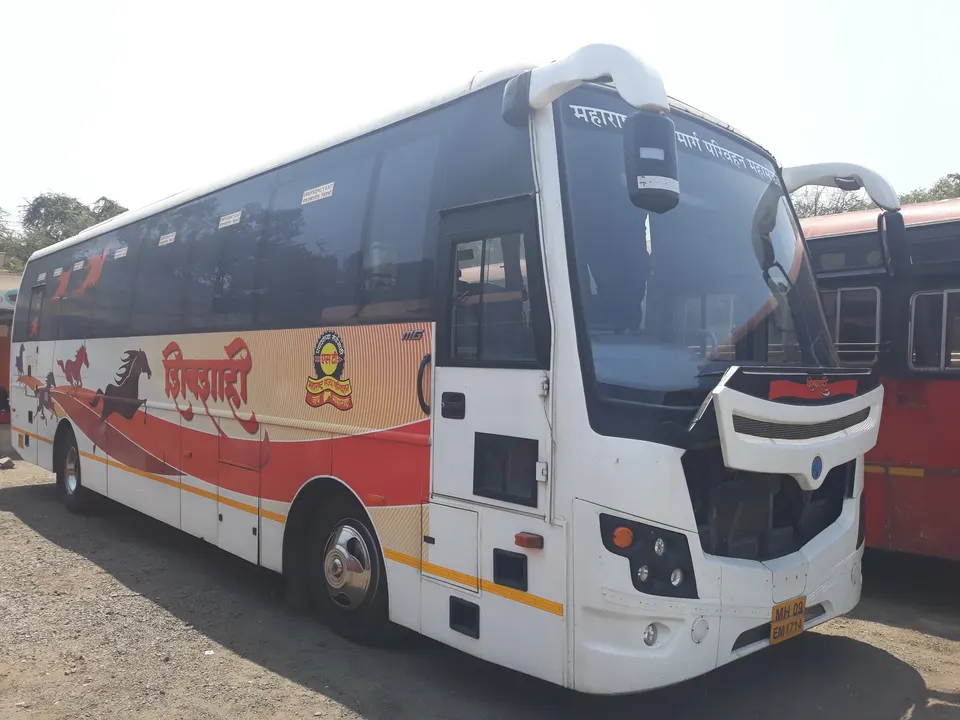A white-and-red Shivshahi air-conditioned MSRTC bus parked beside a red ST bus