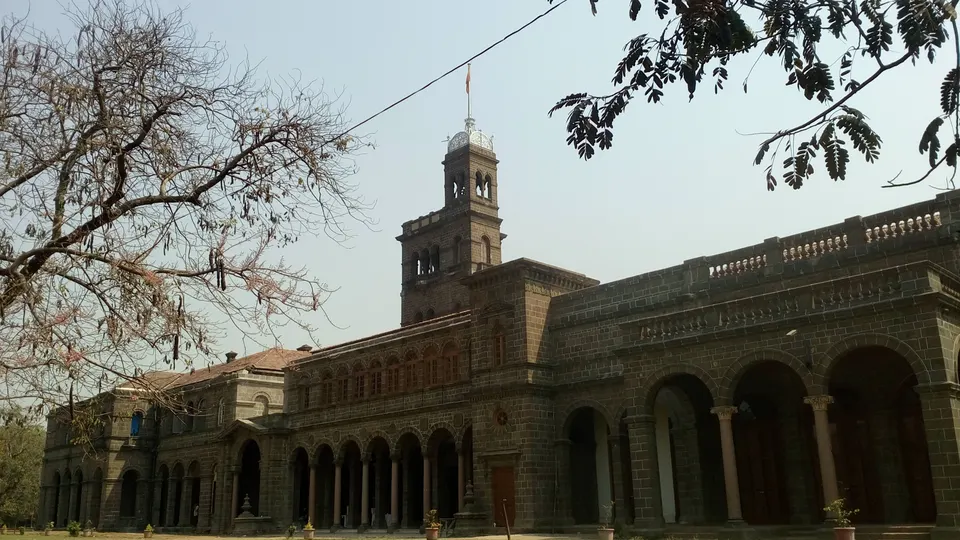 The stone main building of Savitribai Phule Pune University in Pune, with its clock tower