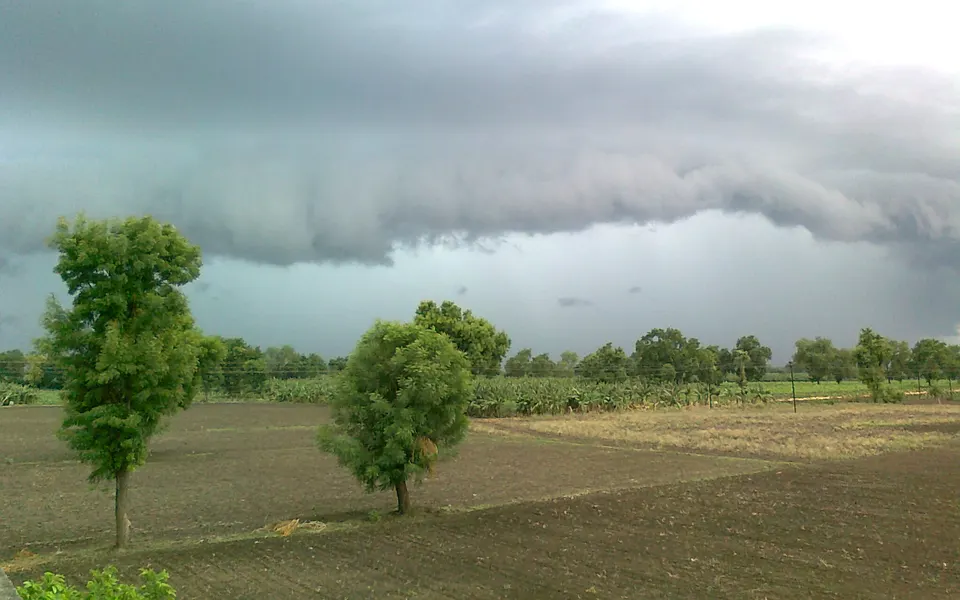 Rain clouds building over ploughed fields and banana plantations at Chinawal in Jalgaon district